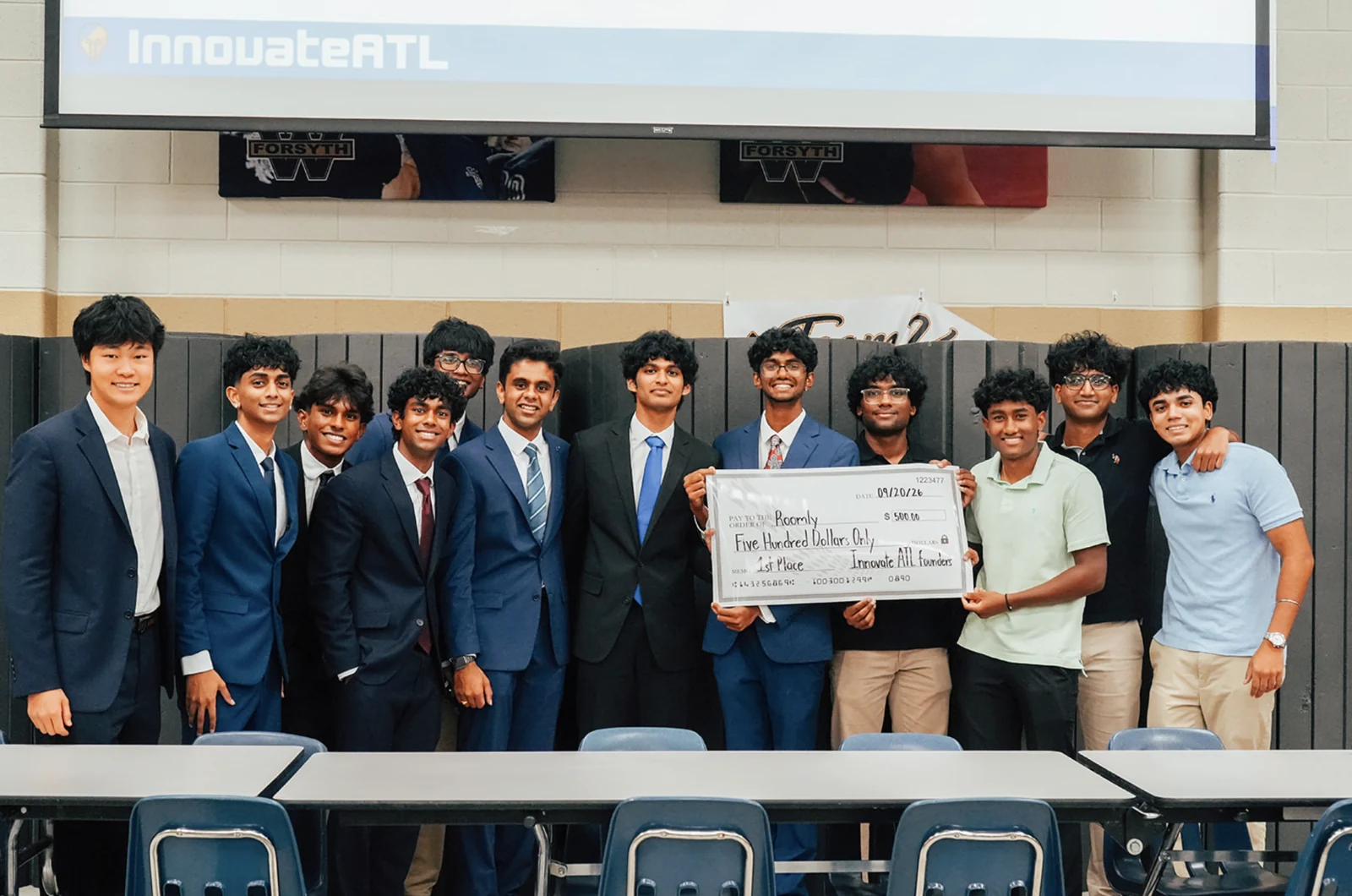 Students and organizers gathered on stage with an award check at InnovateATL 2026.